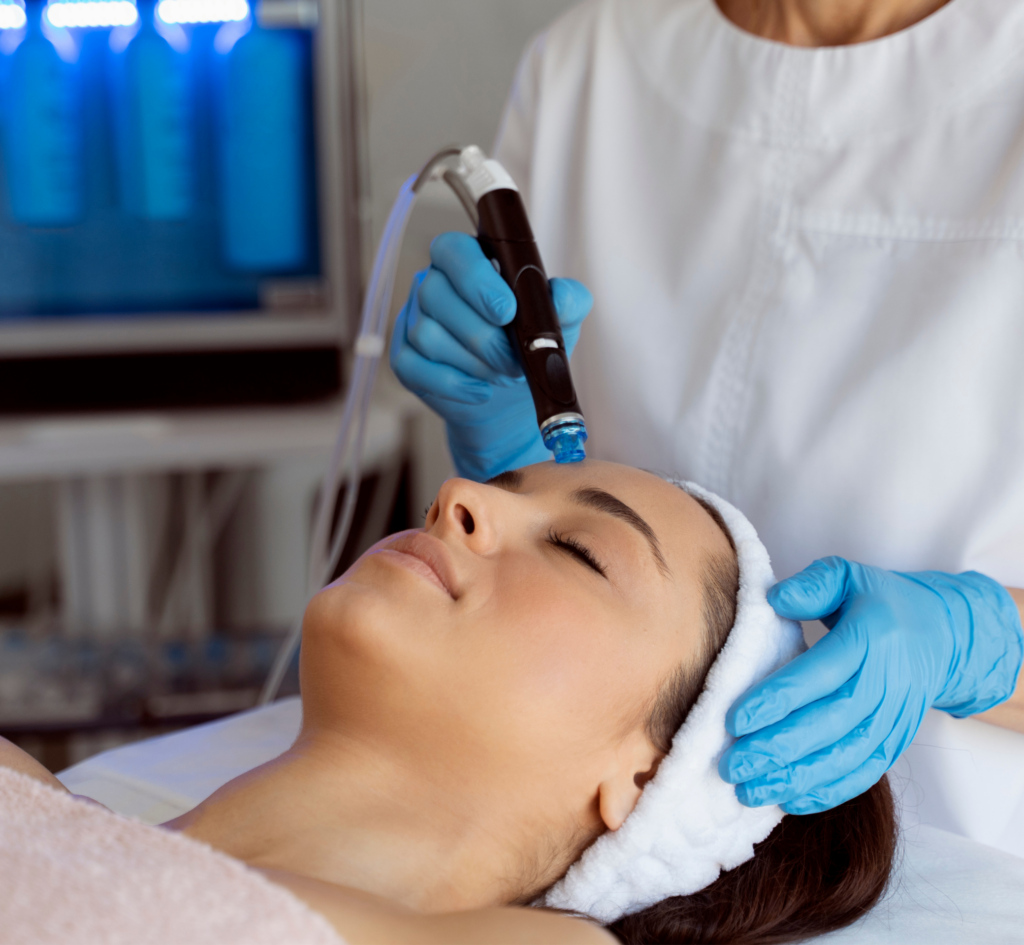Professional female cosmetologist doing hydra facial procedure in cosmetology clinic